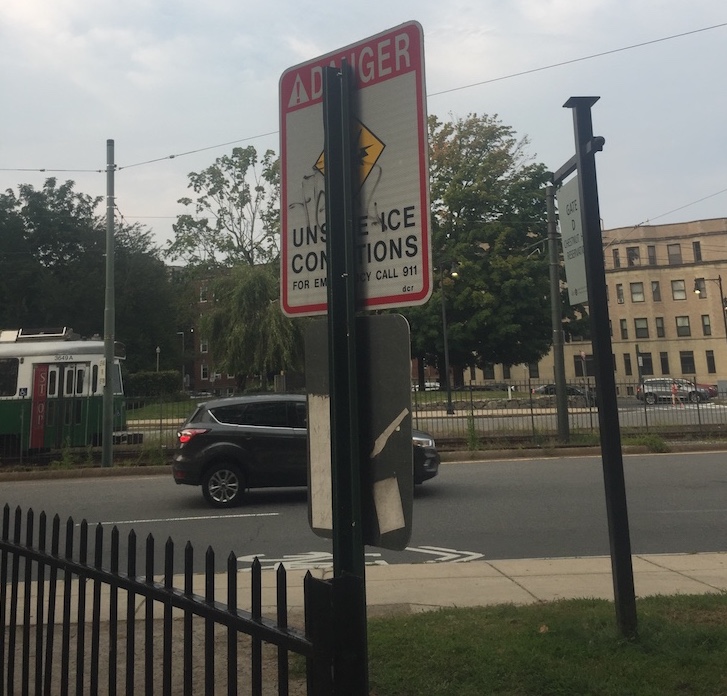 The top sign says &ldquo;DANGER: Unsafe Ice Conditions,&rdquo; but it&rsquo;s mostly blocked by the post.